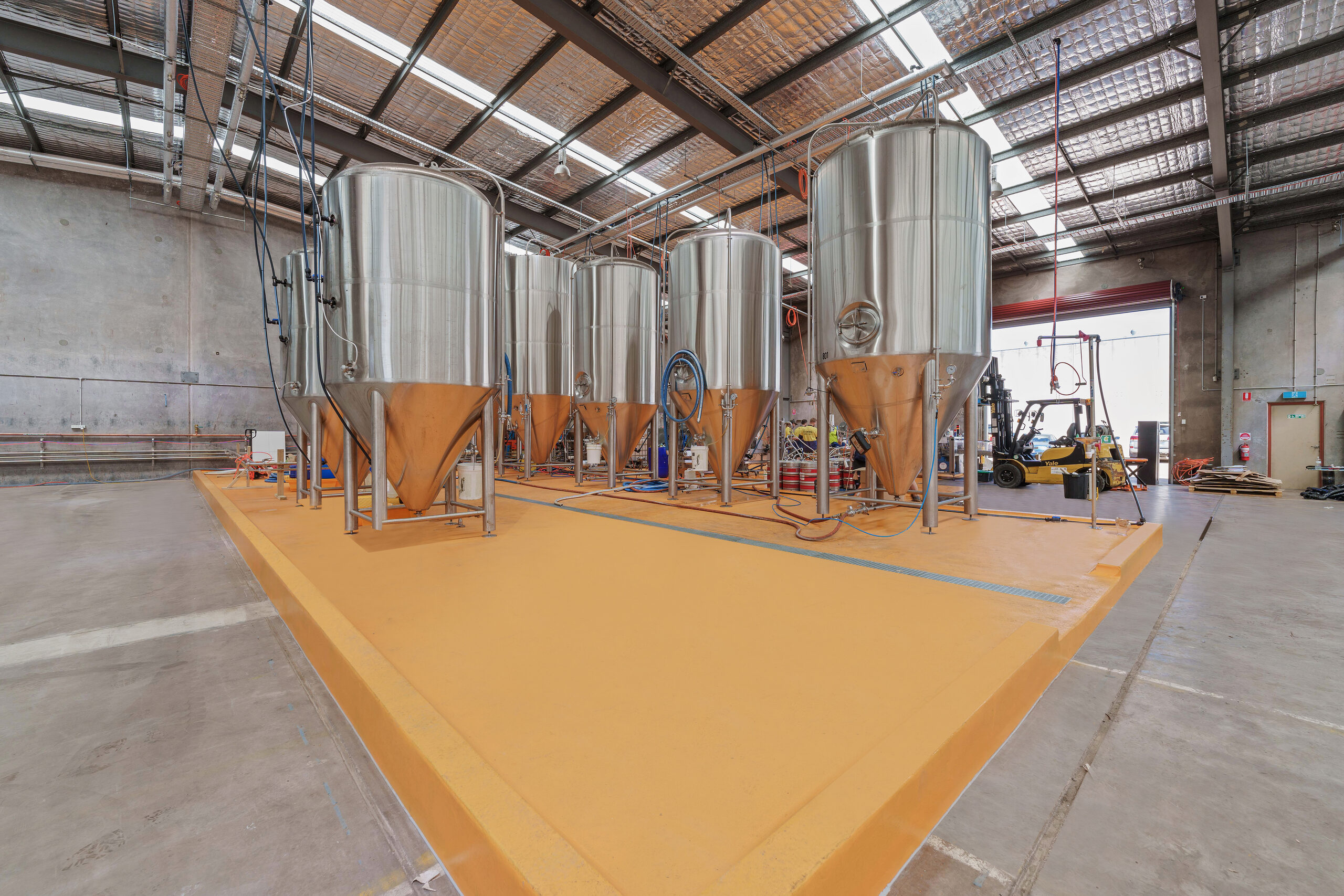 Brewery tanks on a finished epoxy plinth floor